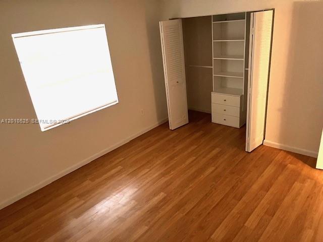 3920 Inverrary Boulevard, Unit 204C Lauderhill, FL 33319 - Photo 14 of 19 an empty room with wooden floor and closet