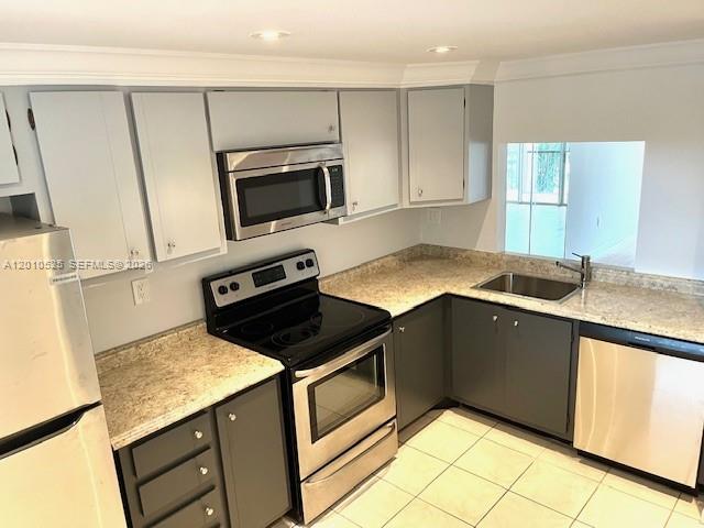 3920 Inverrary Boulevard, Unit 204C Lauderhill, FL 33319 - Photo 2 of 19 a kitchen with granite countertop a stove a microwave a sink and cabinets
