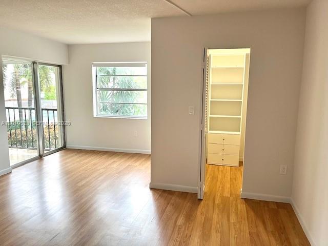 3920 Inverrary Boulevard, Unit 204C Lauderhill, FL 33319 - Photo 5 of 19 a view of an empty room with wooden floor and a window