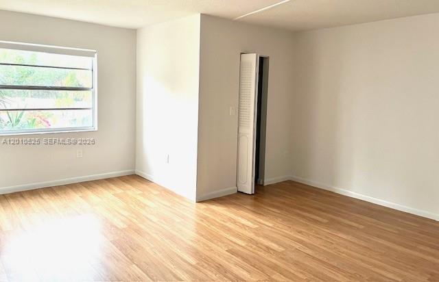 3920 Inverrary Boulevard, Unit 204C Lauderhill, FL 33319 - Photo 6 of 19 an empty room with wooden floor and windows