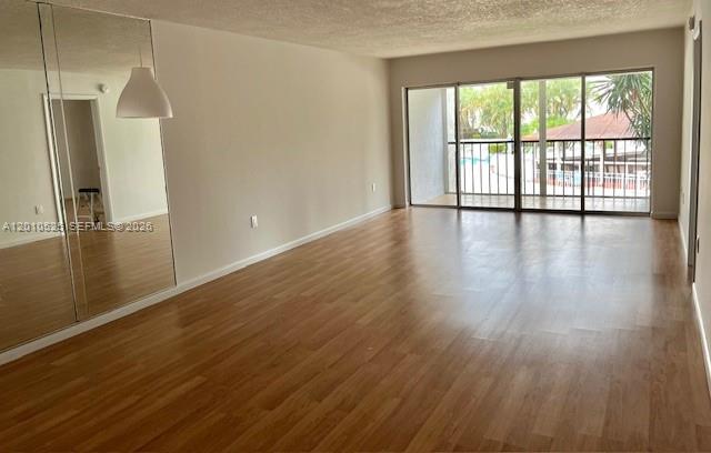 3920 Inverrary Boulevard, Unit 204C Lauderhill, FL 33319 - Photo 7 of 19 an empty room with wooden floor and windows