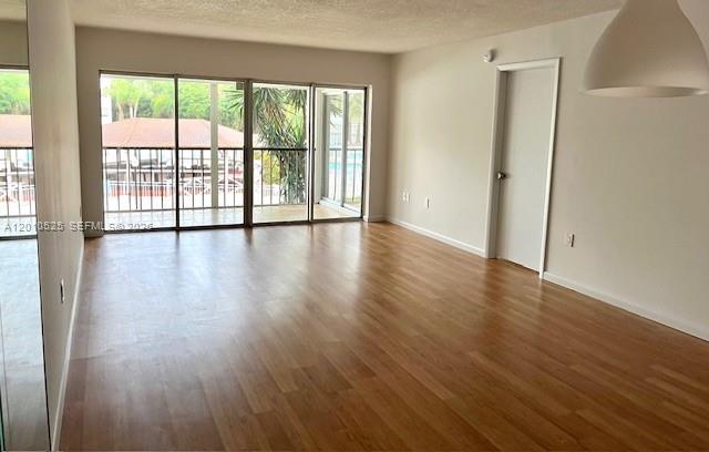 3920 Inverrary Boulevard, Unit 204C Lauderhill, FL 33319 - Photo 8 of 19 a view of an empty room with wooden floor and a window