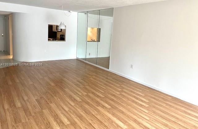 3920 Inverrary Boulevard, Unit 204C Lauderhill, FL 33319 - Photo 9 of 19 a view of a livingroom with wooden floor and flat screen tv