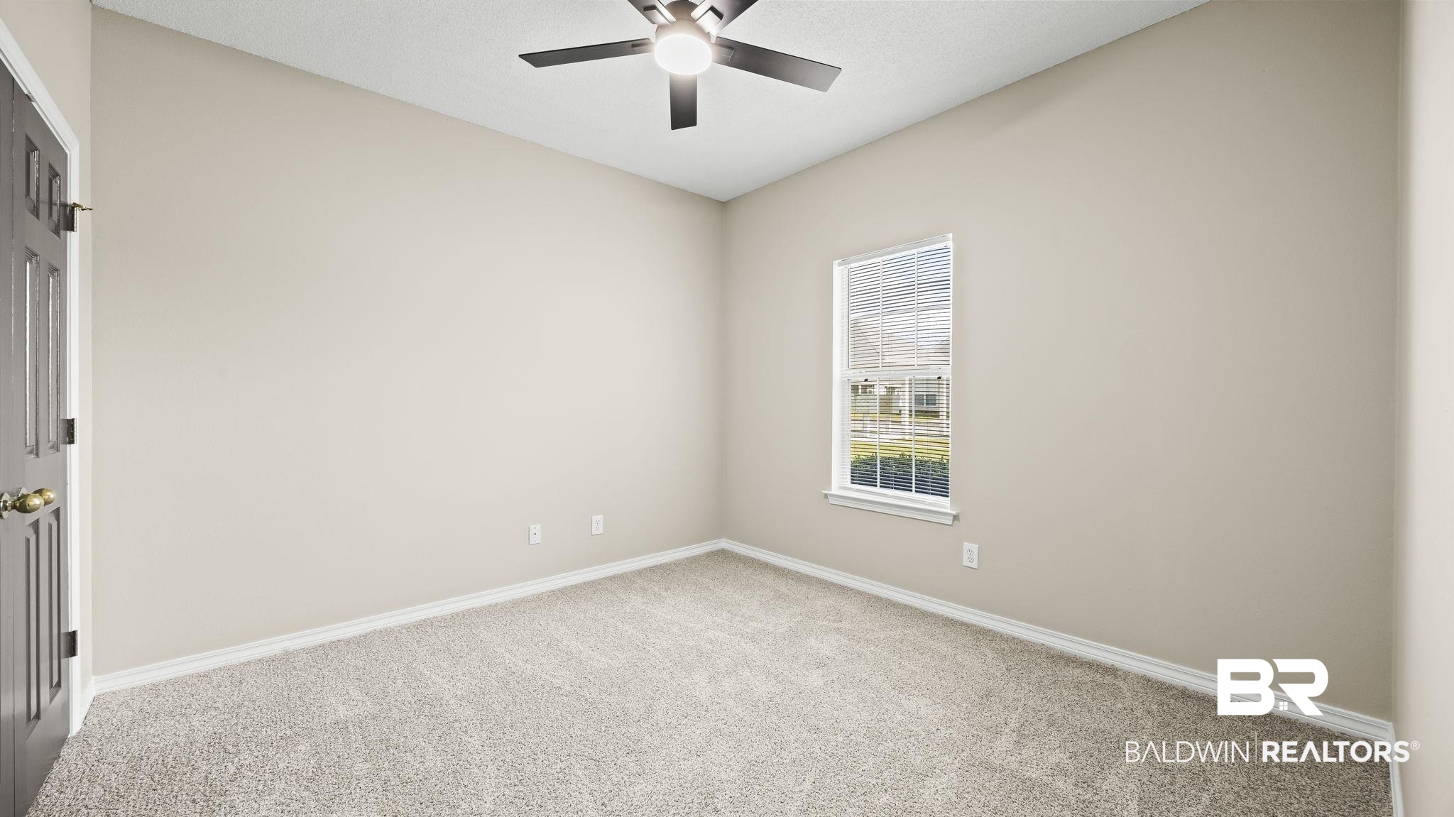 2651 South Juniper Street, Unit 705 Foley, AL 36535 - Photo 20 of 37 Carpeted room with a ceiling fan, neutral wall paint, white baseboards, and a single window