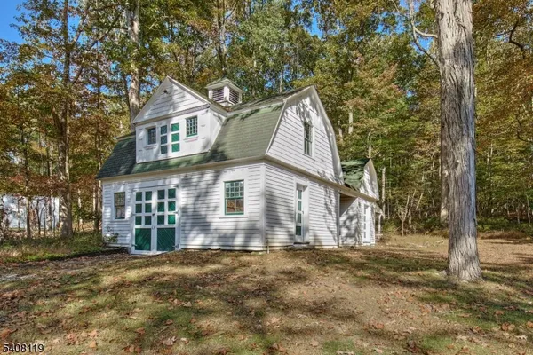 a kitchen with stainless steel appliances granite countertop a table chairs stove and refrigerator