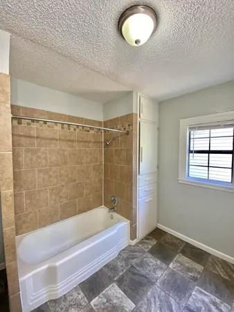 a bathroom with a tub and a shower