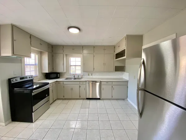 a kitchen with a refrigerator sink and stove