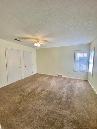 an empty room with a empty space and windows