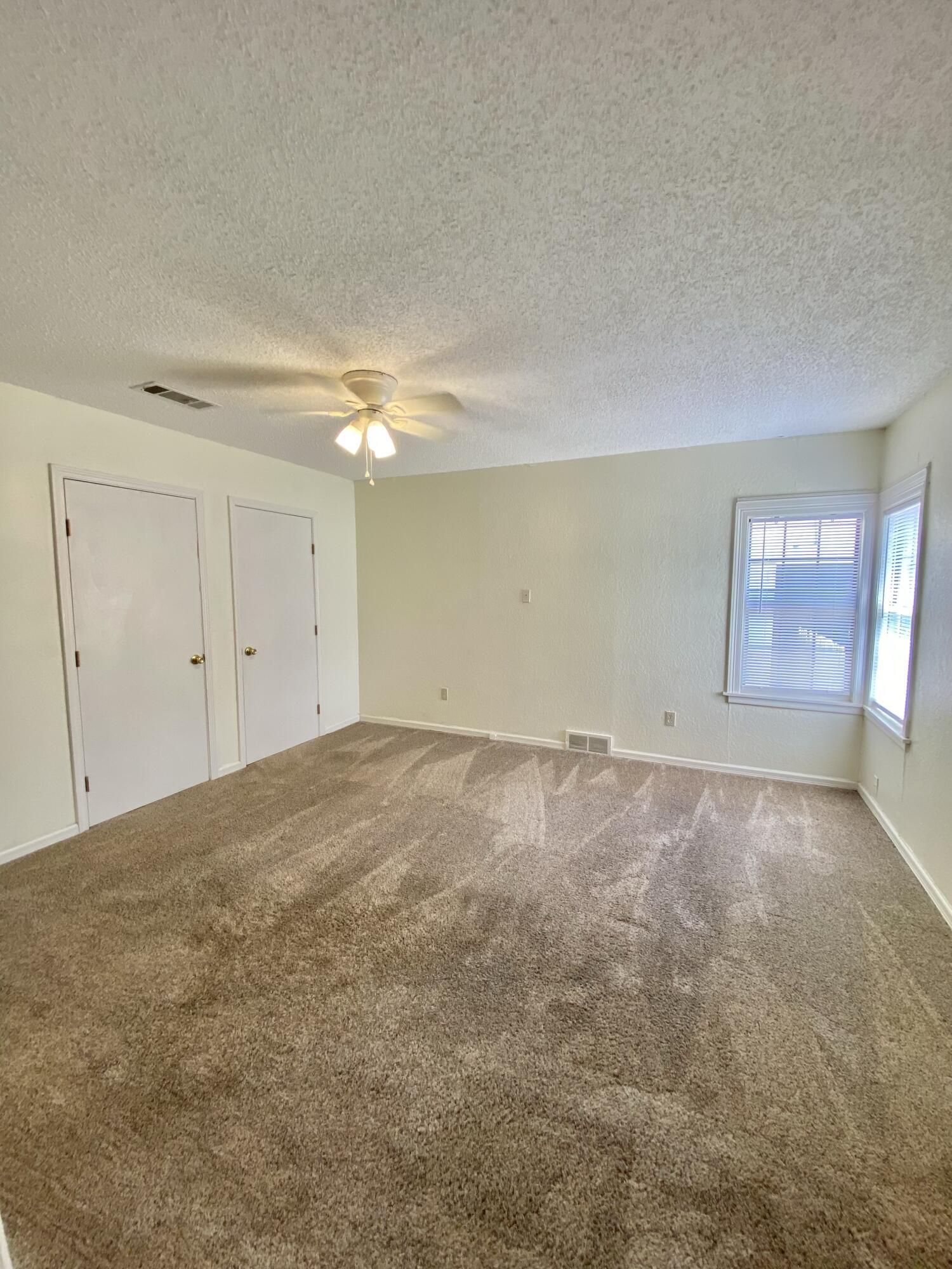 2209 28th Street Lubbock, TX 79411 - Photo 9 of 12 an empty room with a empty space and windows