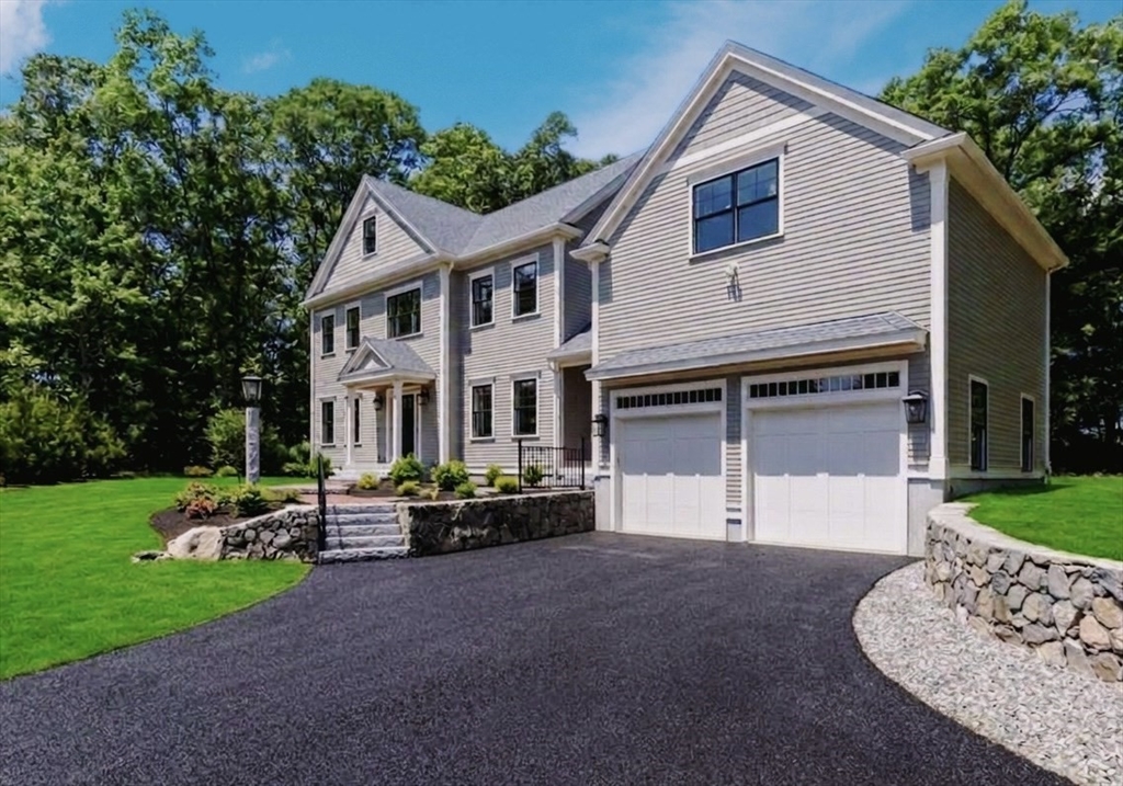 56 Blossomcrest Road Lexington, MA 02421 - Photo 1 of 19 a front view of a house with a garden and trees