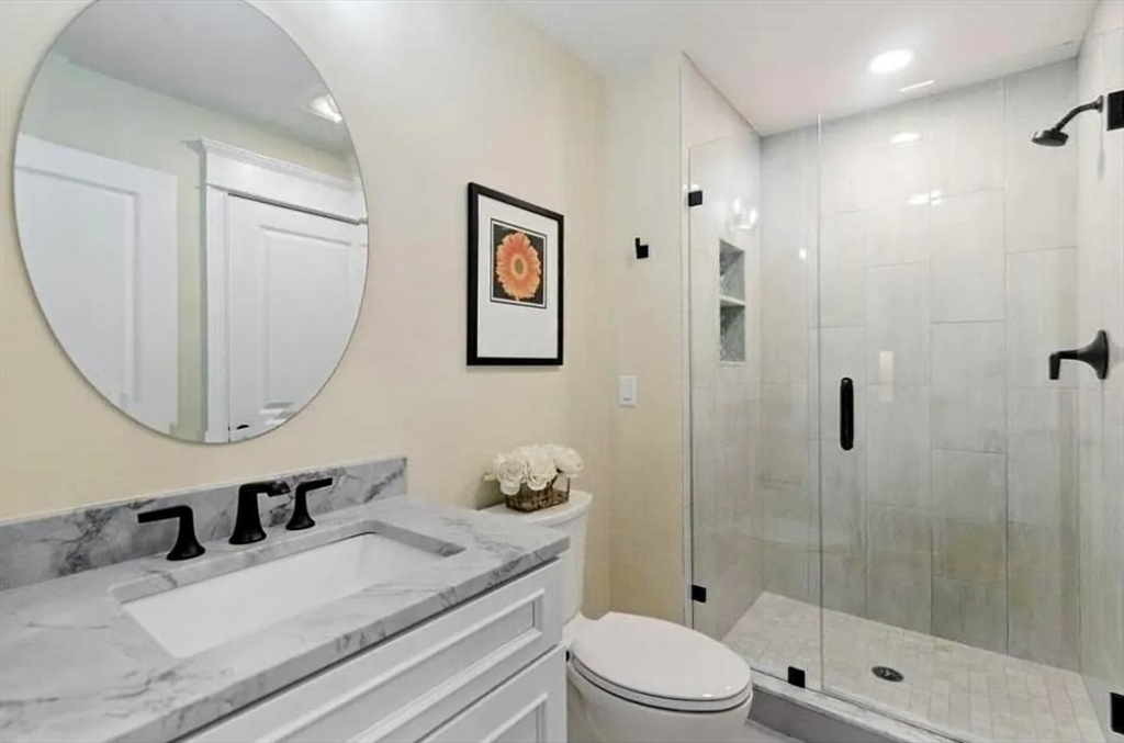 56 Blossomcrest Road Lexington, MA 02421 - Photo 17 of 19 a bathroom with a granite countertop sink a toilet and shower