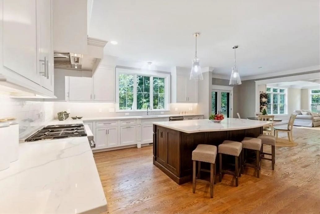 56 Blossomcrest Road Lexington, MA 02421 - Photo 8 of 19 a kitchen with granite countertop a stove a sink a dining table and chairs