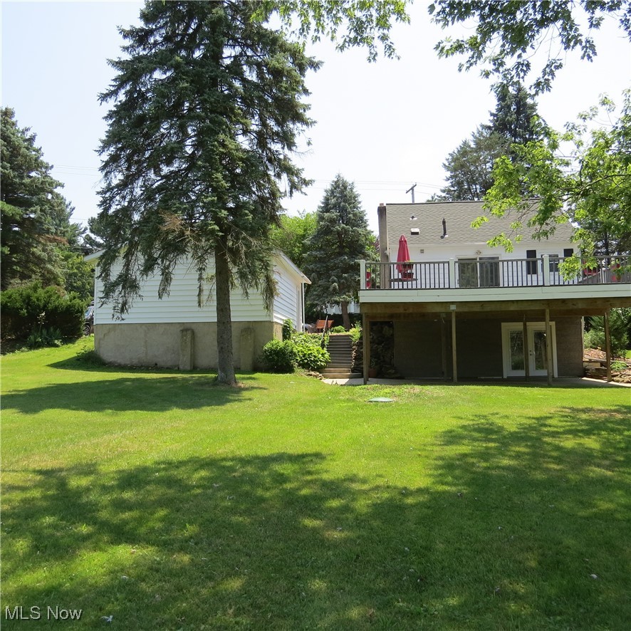 45560 North Ridge Road Amherst, OH 44001 - Photo 20 of 50 View of green lawn with french doors and a wooden deck