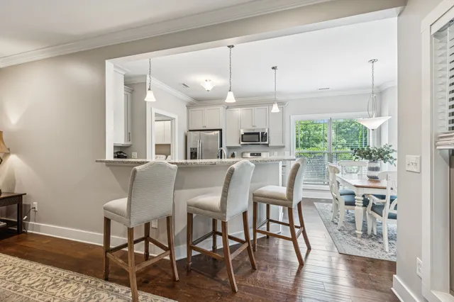 a dining room with furniture window and wooden floor