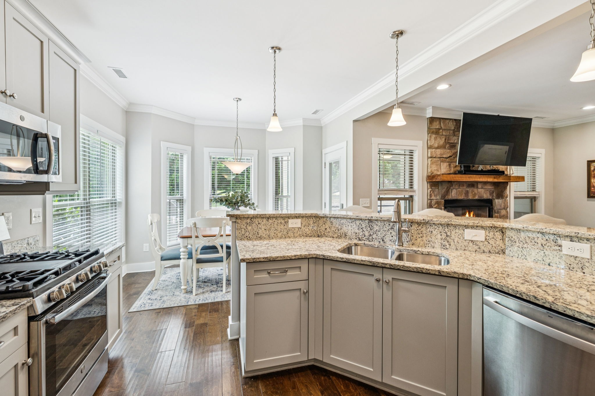 146 Island Way Winchester, TN 37398 - Photo 16 of 49 a kitchen with stainless steel appliances granite countertop a stove top oven a sink dishwasher a dining table and chairs with wooden floor
