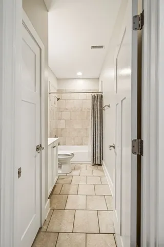 a bathroom with a glass shower door and a bathtub