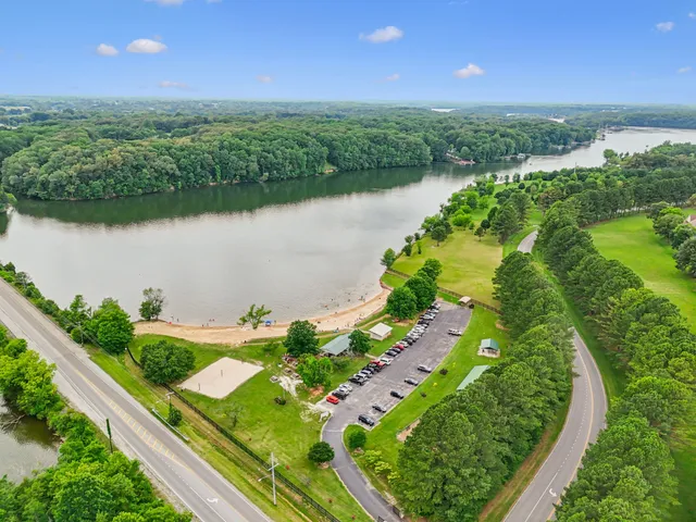 an aerial view of lake residential house with swimming pool and outdoor space