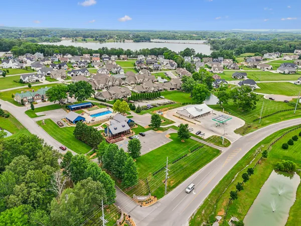 an aerial view of residential houses with outdoor space and pool