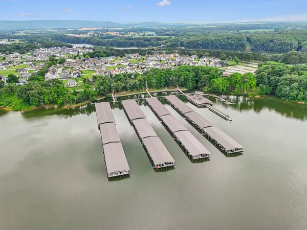 an aerial view of a house with a yard and lake view