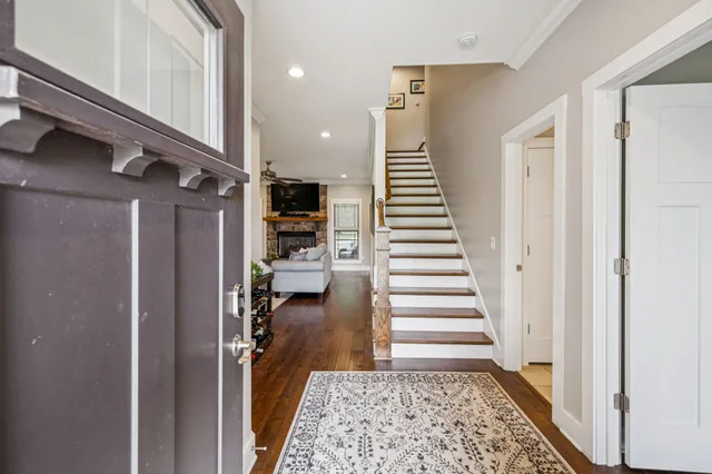 a view of entryway and hall with wooden floor