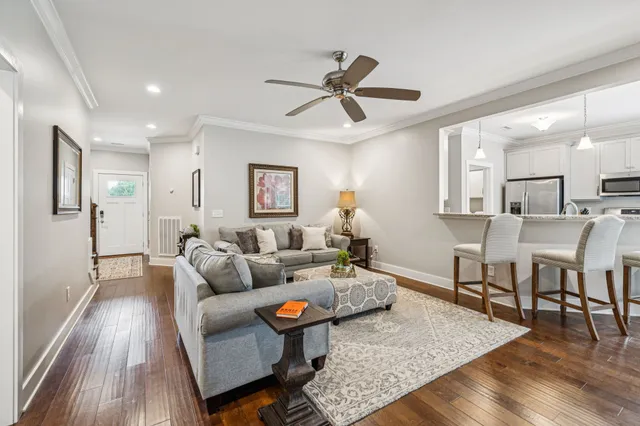 a living room with furniture and a wooden floor