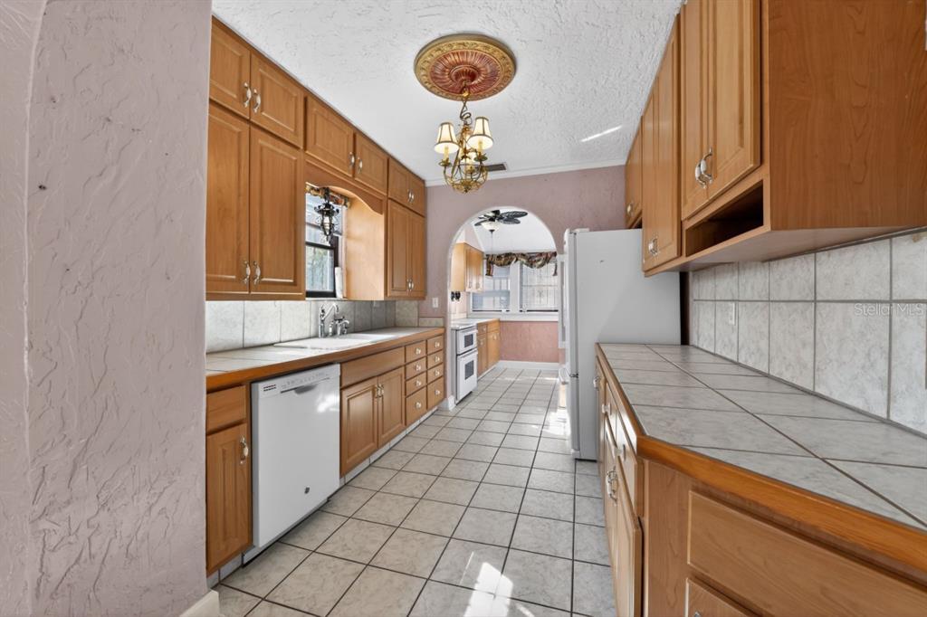 328 Sorrento Street Venice, FL 34285 - Photo 14 of 49 a kitchen with stainless steel appliances granite countertop a sink and a stove