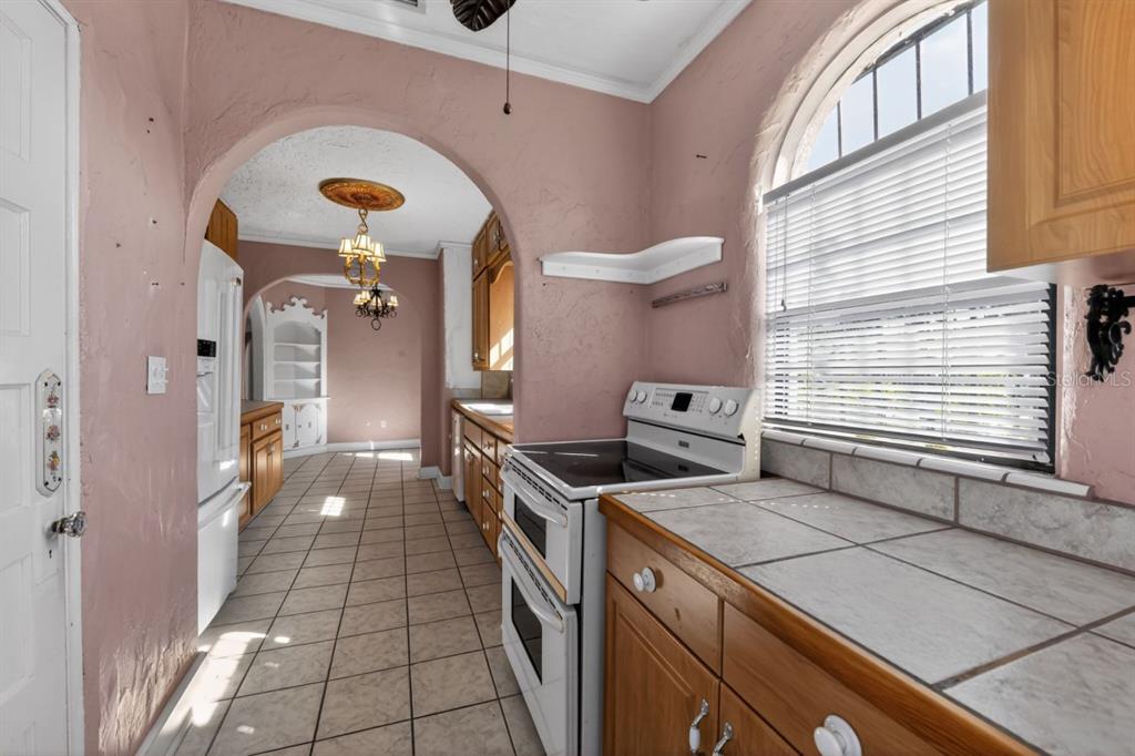 328 Sorrento Street Venice, FL 34285 - Photo 16 of 49 a kitchen with a stove and a refrigerator