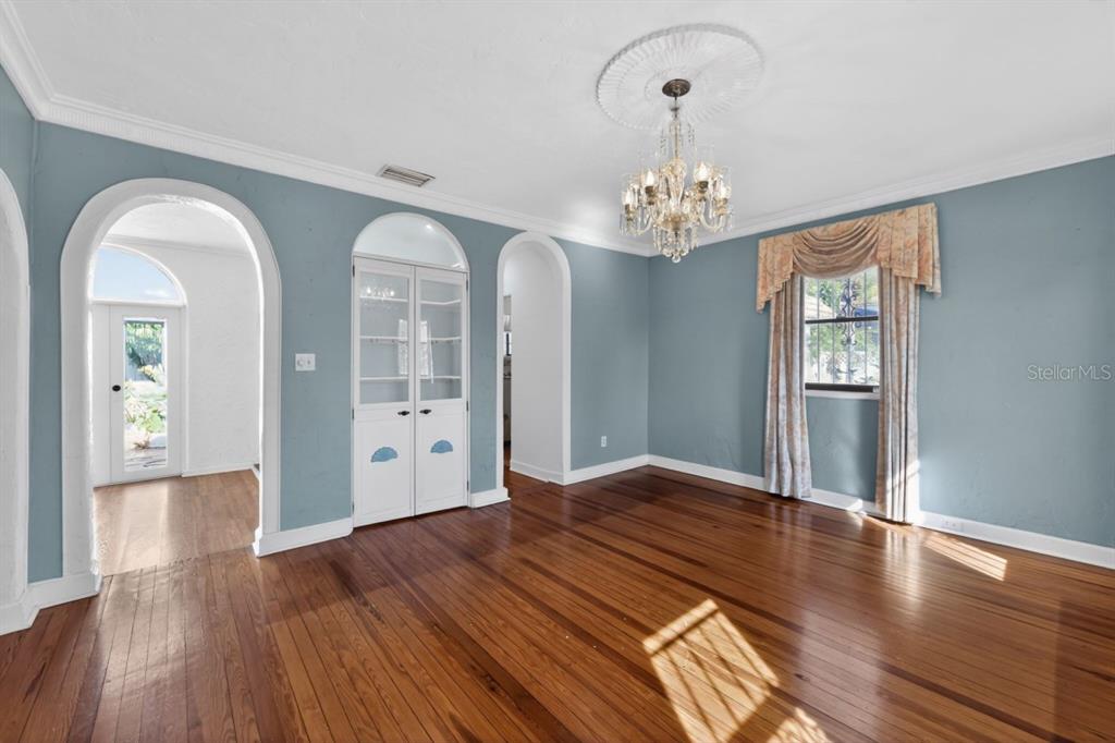 328 Sorrento Street Venice, FL 34285 - Photo 18 of 49 a view of an empty room with window and wooden floor