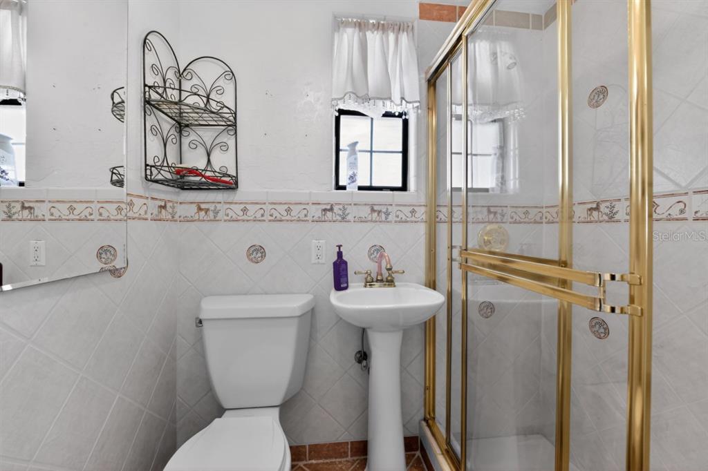 328 Sorrento Street Venice, FL 34285 - Photo 19 of 49 a bathroom with a toilet a sink and mirror