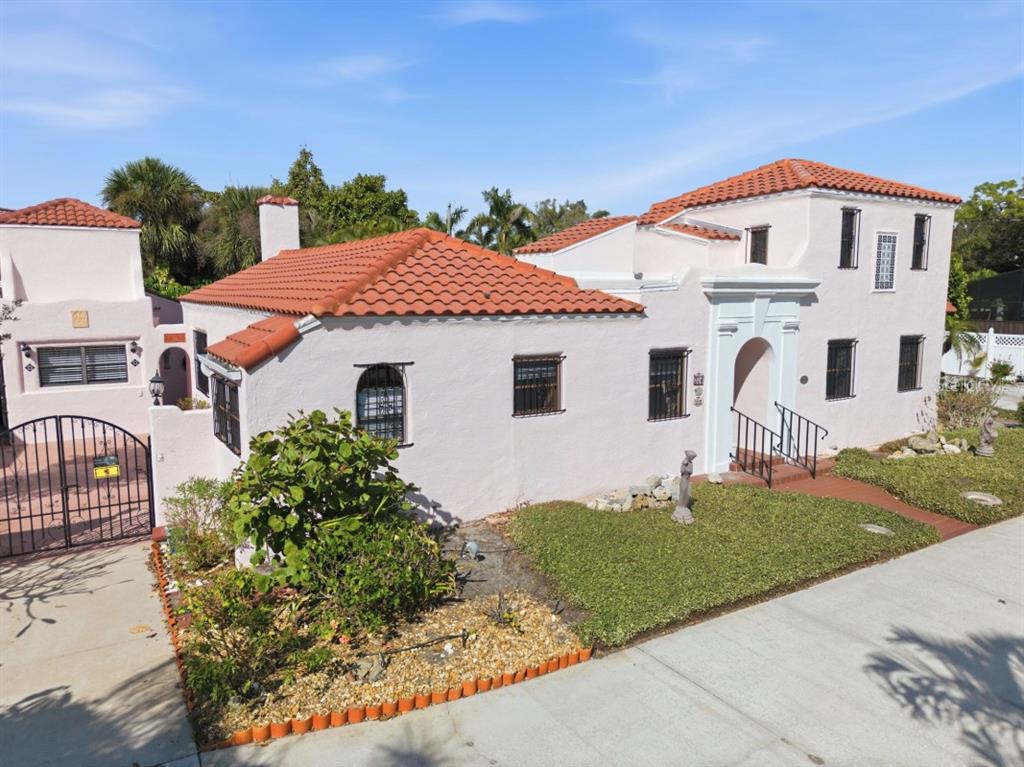 328 Sorrento Street Venice, FL 34285 - Photo 2 of 49 a view of a white house with a small yard and a large tree