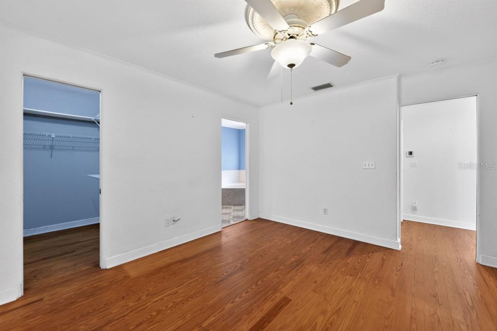 328 Sorrento Street Venice, FL 34285 - Photo 22 of 49 a view of an empty room with wooden floor