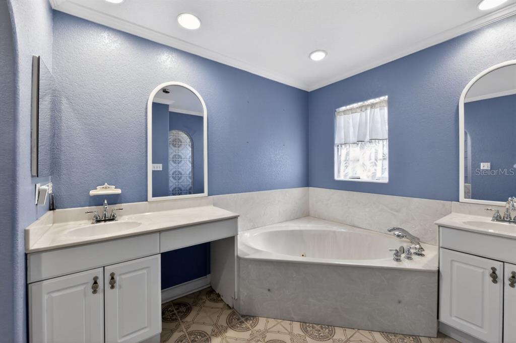 328 Sorrento Street Venice, FL 34285 - Photo 24 of 49 a bathroom with a bathtub a mirror a sink and vanity