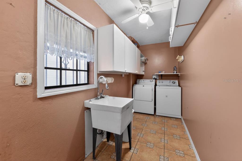 328 Sorrento Street Venice, FL 34285 - Photo 32 of 49 a kitchen with a sink cabinets and window