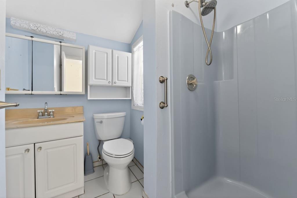 328 Sorrento Street Venice, FL 34285 - Photo 40 of 49 a bathroom with a granite countertop toilet a sink and a mirror