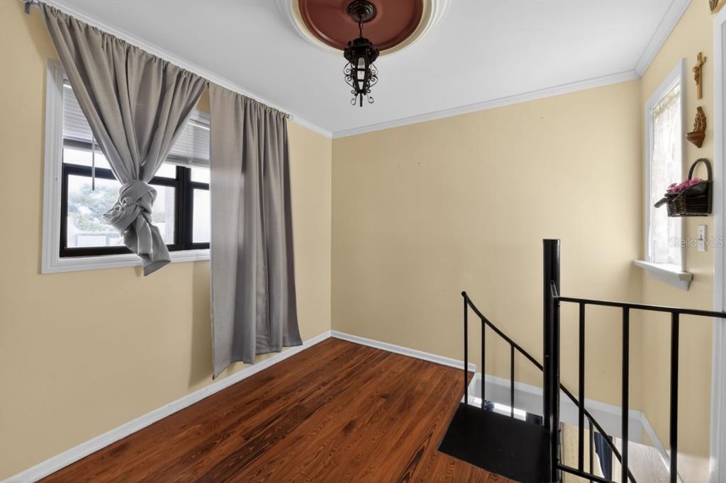 328 Sorrento Street Venice, FL 34285 - Photo 43 of 49 a view of a hallway with wooden floor and staircase