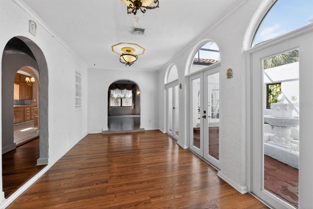 328 Sorrento Street Venice, FL 34285 - Photo 7 of 49 a view of a hallway with wooden floor and a kitchen