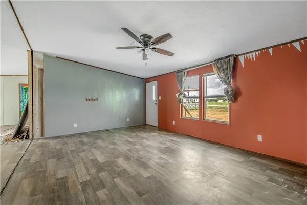 a view of a livingroom with a ceiling fan and window