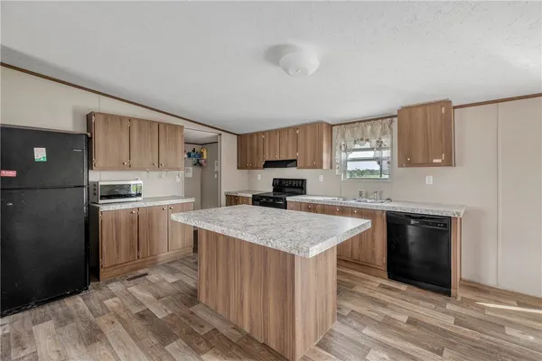 a kitchen with a stove top oven sink and cabinets