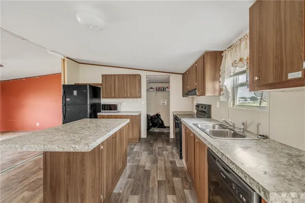 a kitchen with stainless steel appliances granite countertop a stove a sink dishwasher and a refrigerator