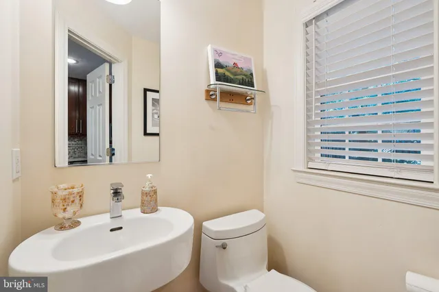 a bathroom with a sink mirror and toilet