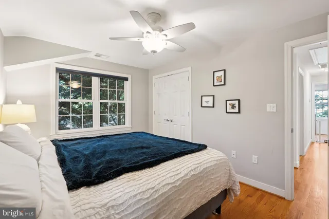 a bed sitting in a bedroom next to a window