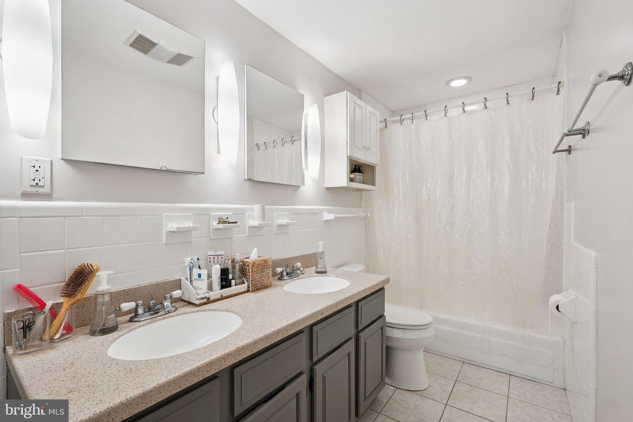 1432 Crestridge Drive Silver Spring, MD 20910 - Photo 20 of 52 a bathroom with a granite countertop sink toilet a mirror and shower