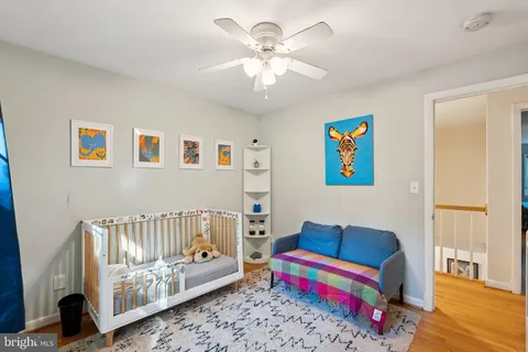 a bedroom with furniture and a wooden floor