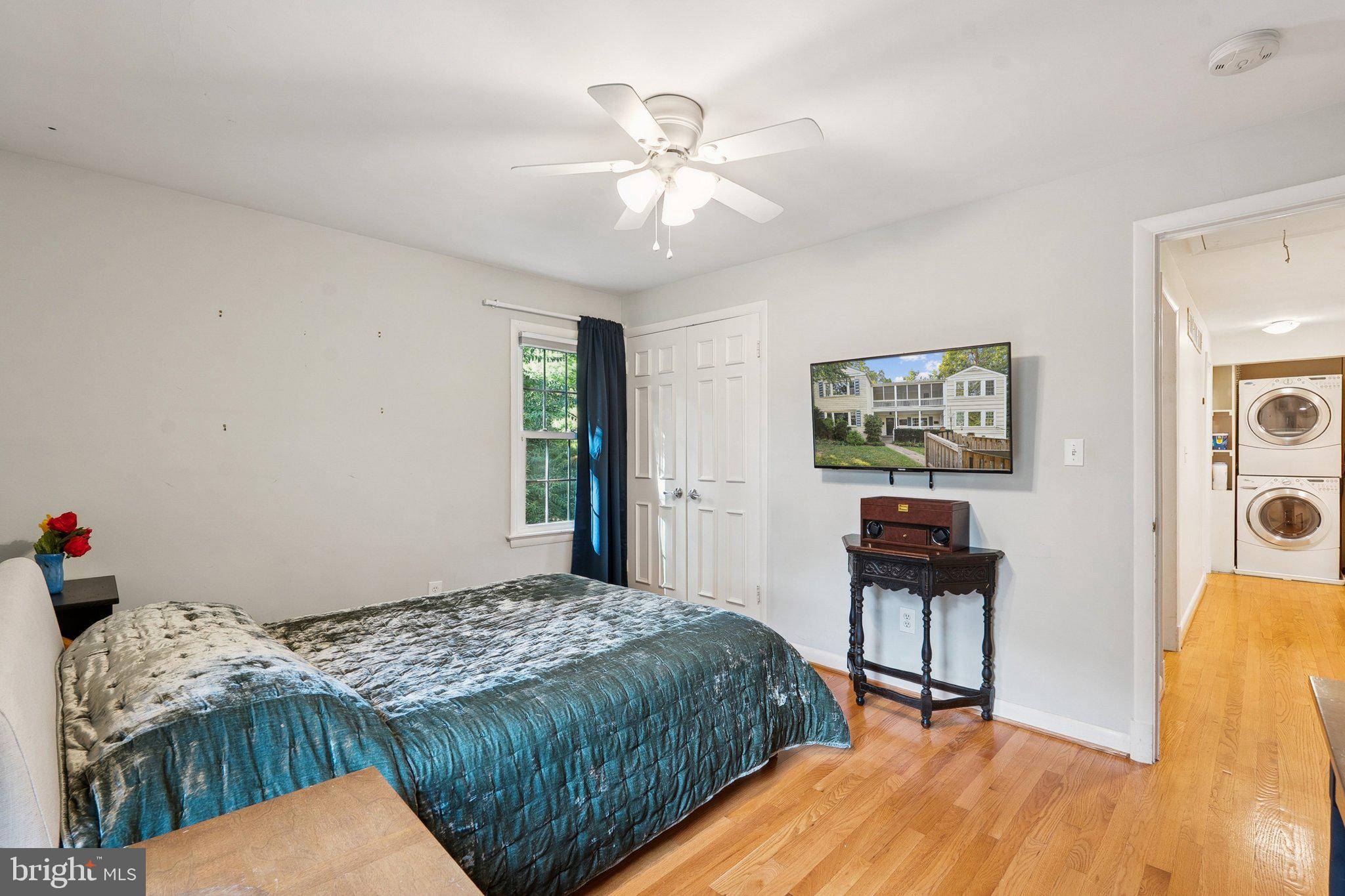 1432 Crestridge Drive Silver Spring, MD 20910 - Photo 26 of 52 a bedroom with a bed and a chandelier