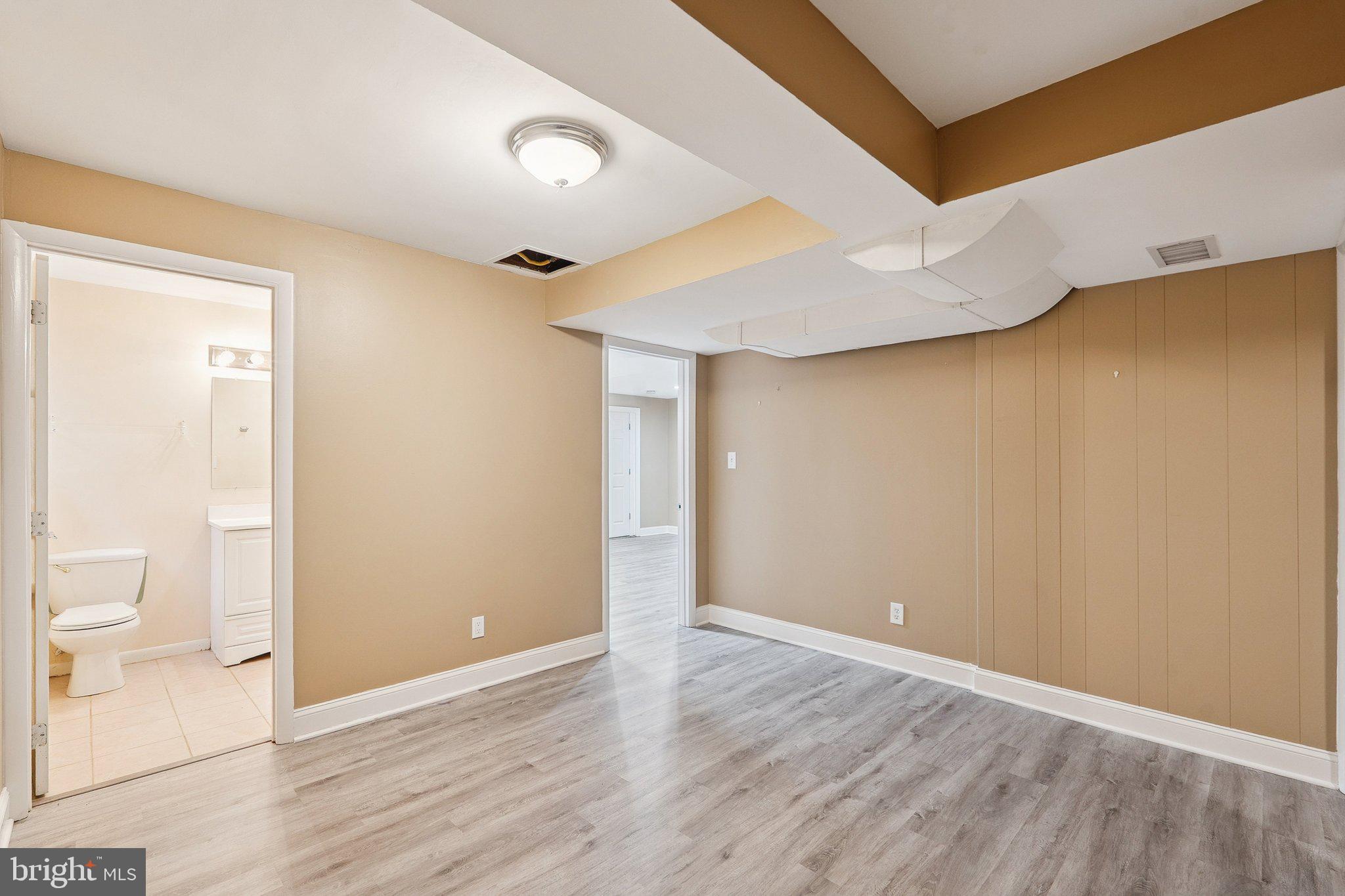 1432 Crestridge Drive Silver Spring, MD 20910 - Photo 31 of 52 a view of a room with wooden floor and a toilet