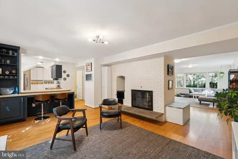 a living room with furniture a fireplace and a table