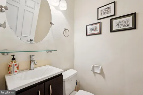 a bathroom with a sink vanity and toilet