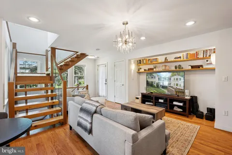 a living room with furniture and a chandelier