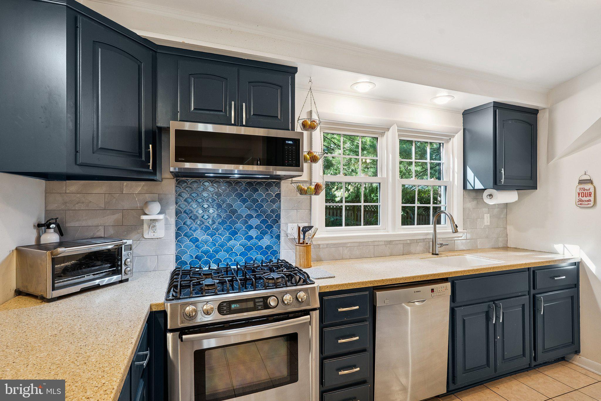 1432 Crestridge Drive Silver Spring, MD 20910 - Photo 41 of 52 a kitchen with a stove microwave and sink