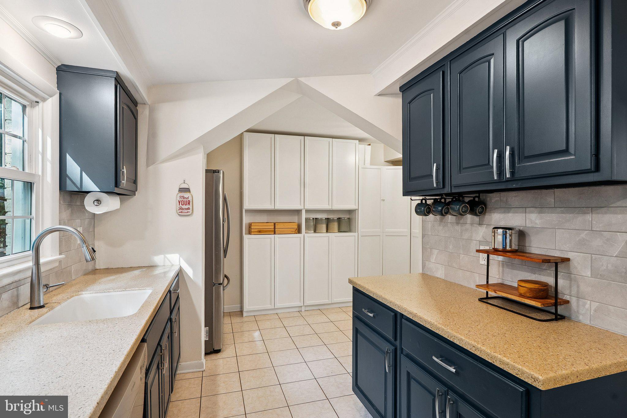 1432 Crestridge Drive Silver Spring, MD 20910 - Photo 42 of 52 a kitchen with a sink a stove and cabinets